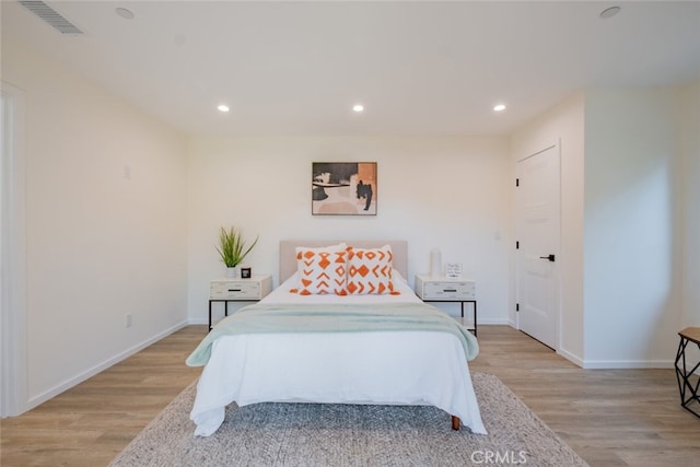bedroom featuring recessed lighting, visible vents, and light wood finished floors