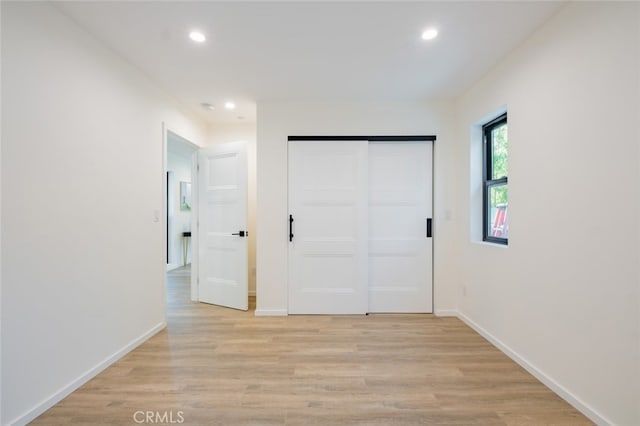 interior space featuring light wood-style floors, baseboards, and recessed lighting