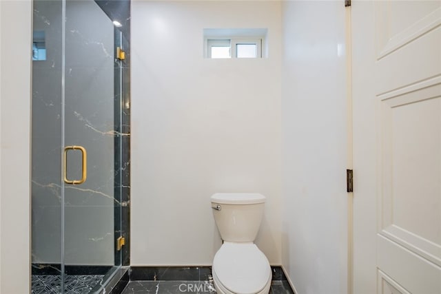 bathroom with a stall shower and toilet