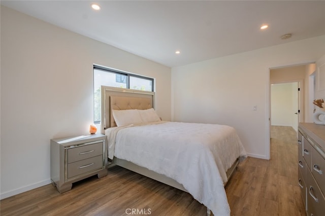bedroom featuring recessed lighting, baseboards, and wood finished floors