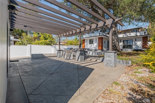 view of patio / terrace featuring fence and a pergola