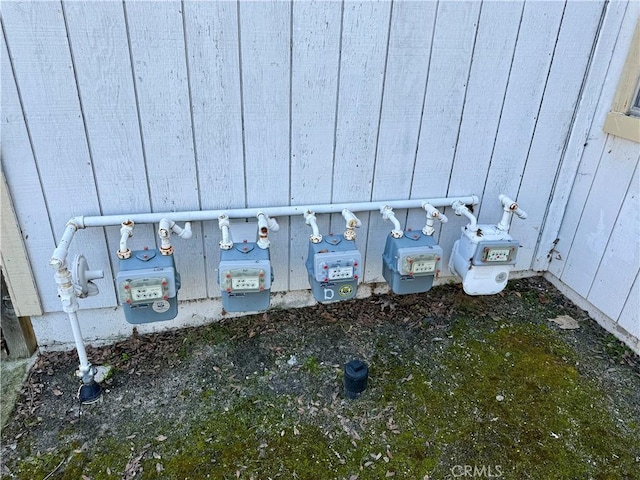 exterior details featuring gas meter and board and batten siding