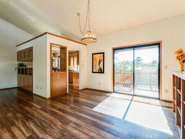 unfurnished dining area with lofted ceiling, baseboards, a chandelier, and wood finished floors