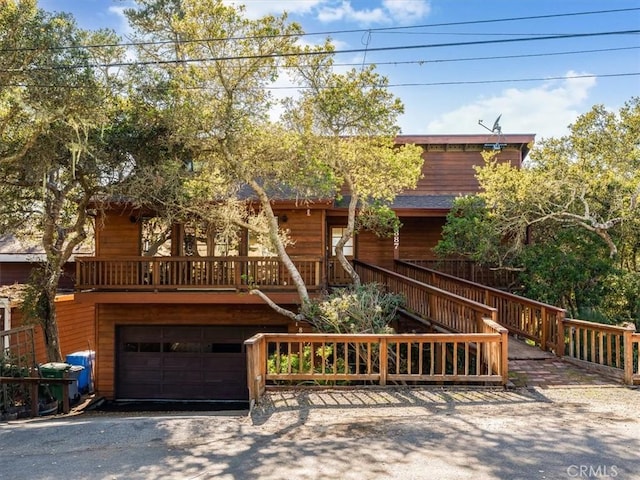 view of front of house featuring a garage and a wooden deck