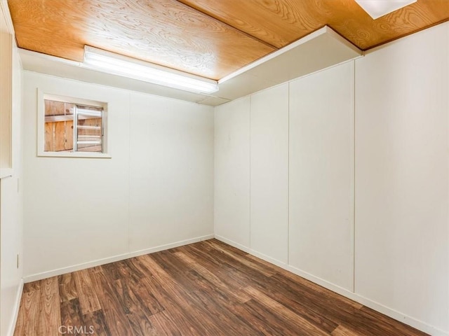 unfurnished room with baseboards and wood finished floors