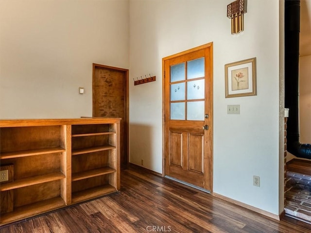 doorway with dark wood-style flooring