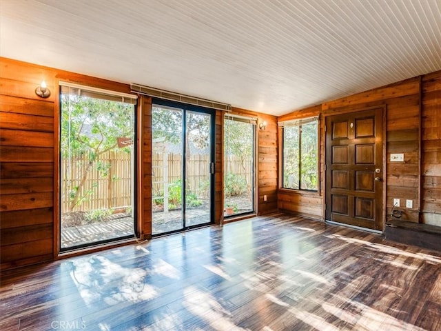 unfurnished sunroom with lofted ceiling and a healthy amount of sunlight