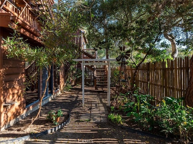 view of yard with stairway and fence