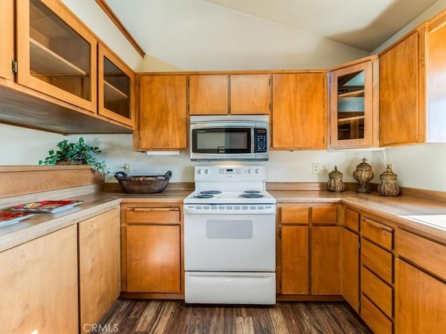 kitchen with electric range, glass insert cabinets, stainless steel microwave, dark wood-type flooring, and light countertops