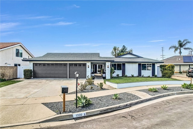 ranch-style house with a front lawn, concrete driveway, a garage, and fence