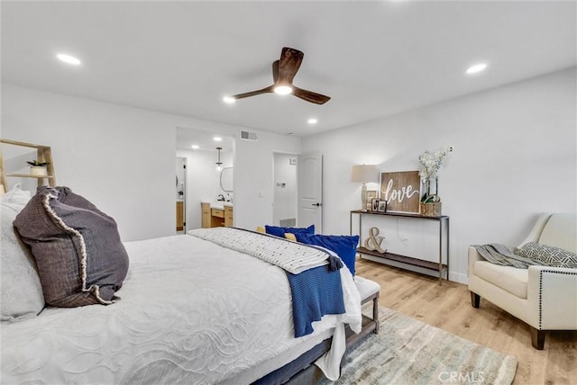 bedroom featuring recessed lighting, visible vents, ensuite bathroom, a ceiling fan, and wood finished floors