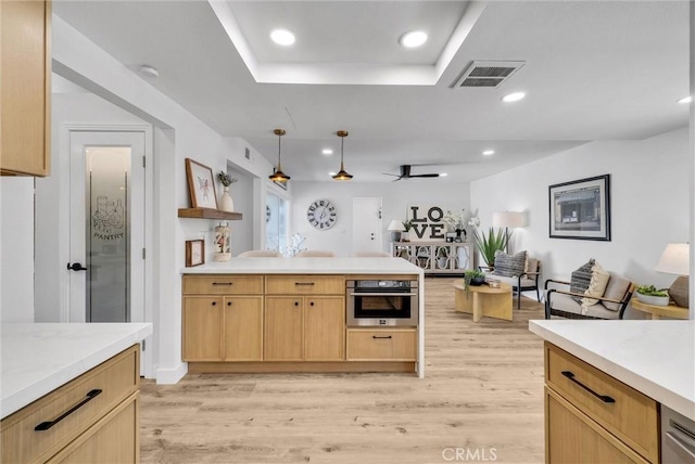 kitchen featuring light wood finished floors, visible vents, light countertops, stainless steel oven, and recessed lighting