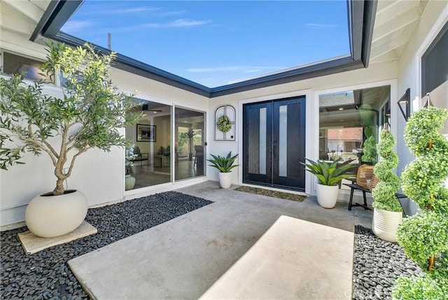 property entrance with a patio area and stucco siding