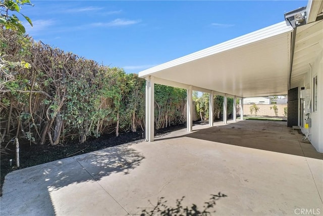 view of patio with fence and an attached carport