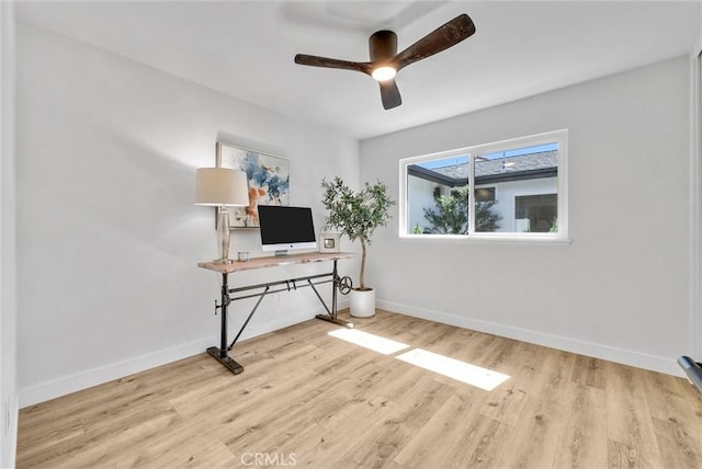 home office featuring ceiling fan, baseboards, and wood finished floors