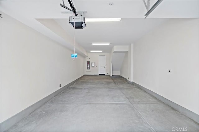 garage featuring baseboards and a garage door opener