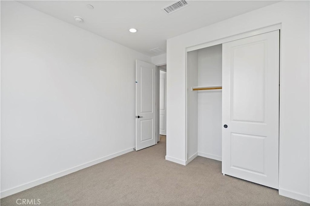 unfurnished bedroom with carpet, recessed lighting, a closet, visible vents, and baseboards