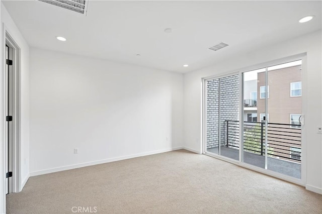 unfurnished room with carpet floors, recessed lighting, and visible vents