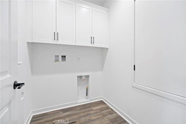 laundry area with gas dryer hookup, washer hookup, baseboards, cabinet space, and dark wood-style floors