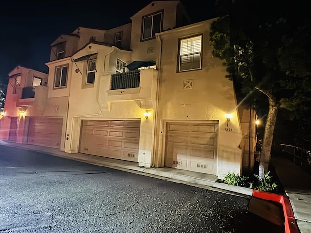 view of front of home with a garage and stucco siding