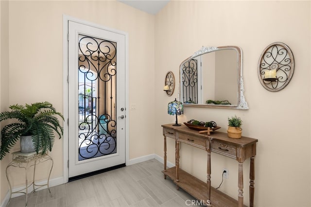 foyer featuring baseboards