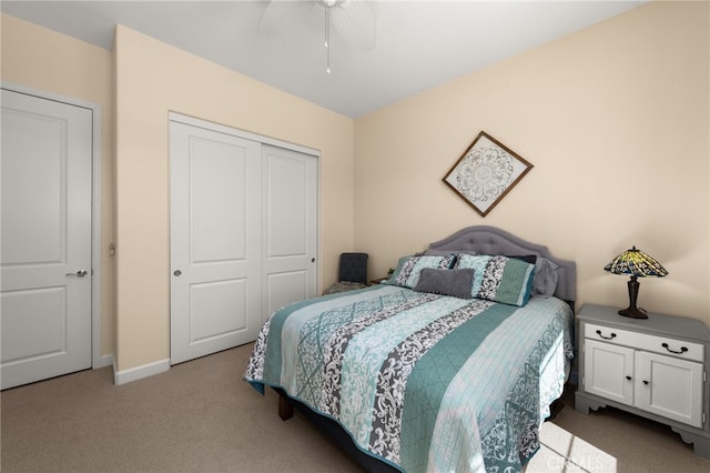 bedroom with carpet flooring, a ceiling fan, a closet, and baseboards