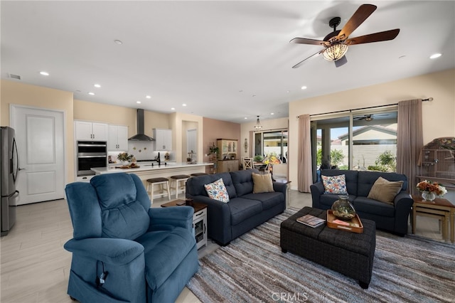 living area featuring light wood-style floors, recessed lighting, visible vents, and ceiling fan