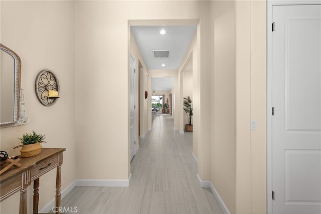 corridor featuring recessed lighting, visible vents, and baseboards