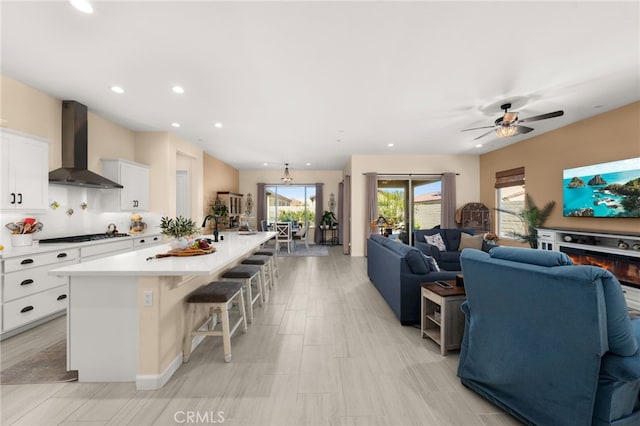 living area with recessed lighting and ceiling fan