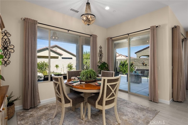 dining area with visible vents, baseboards, and a chandelier