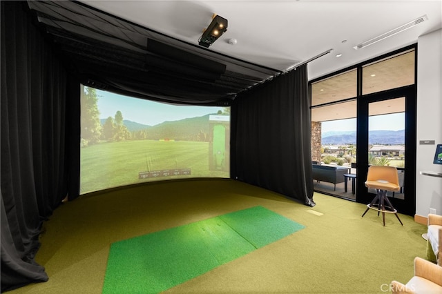 playroom with visible vents, a mountain view, and golf simulator