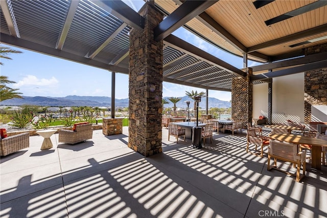 view of patio featuring a mountain view and outdoor dining space