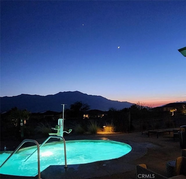 pool at dusk with a mountain view