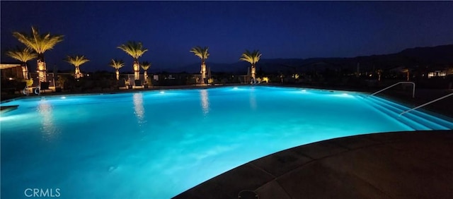 pool at twilight featuring a community pool