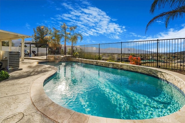 view of swimming pool with a patio, cooling unit, fence, a pergola, and a pool with connected hot tub