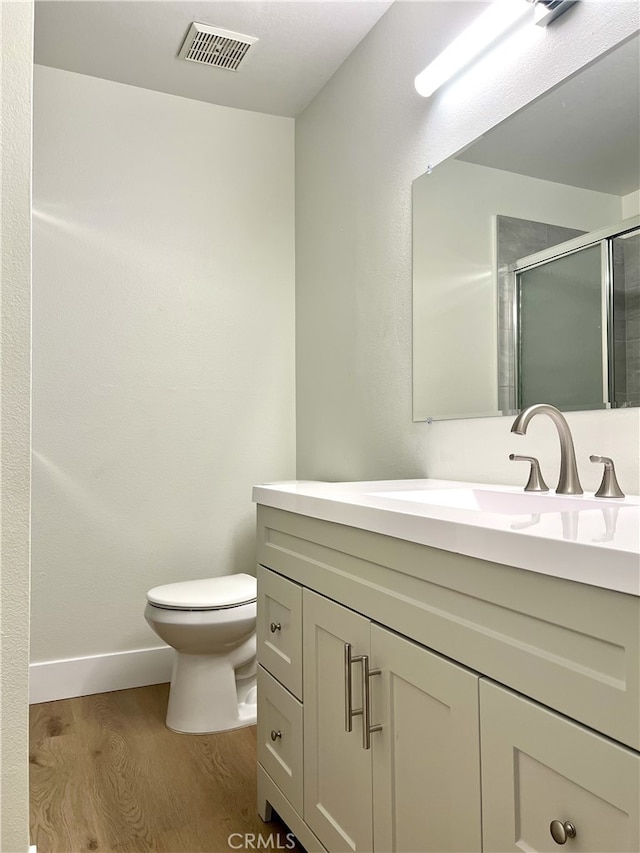 700 W La Veta # A4, Orange, CA 92868 - bathroom with vanity, toilet, a stall shower, wood finished floors, and baseboards