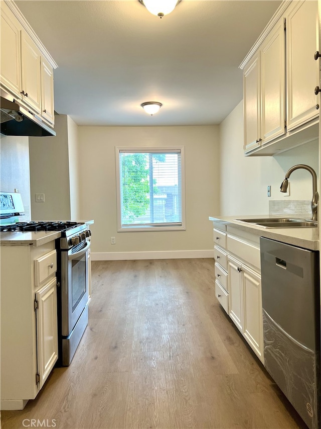 700 W La Veta # A4, Orange, CA 92868 - kitchen featuring appliances with stainless steel finishes, a sink, light wood-type flooring, light countertops, and baseboards
