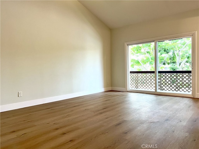 700 W La Veta # A4, Orange, CA 92868 - spare room with wood finished floors, vaulted ceiling, and baseboards