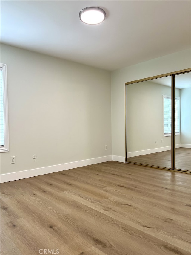 700 W La Veta # A4, Orange, CA 92868 - unfurnished bedroom with wood finished floors, baseboards, and a closet