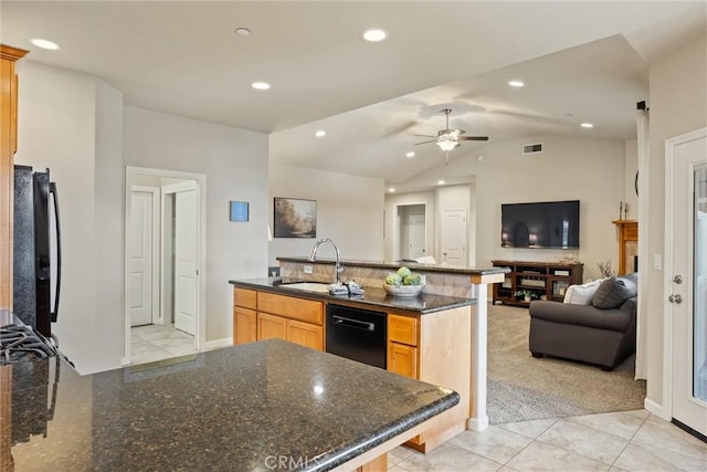 kitchen with visible vents, open floor plan, lofted ceiling, black appliances, and a sink