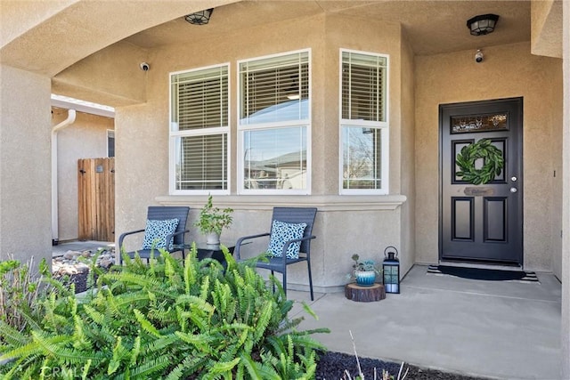 entrance to property with stucco siding