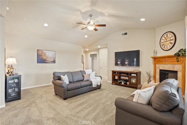 carpeted living area with visible vents, baseboards, lofted ceiling, recessed lighting, and a tile fireplace