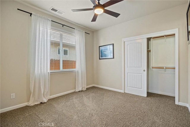 unfurnished bedroom with baseboards, visible vents, carpet floors, ceiling fan, and a closet