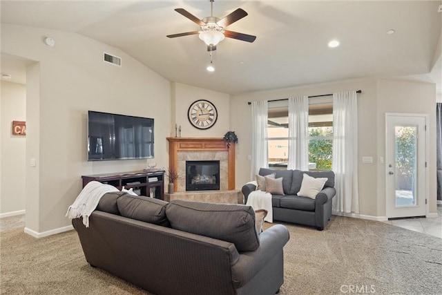 living area with visible vents, a fireplace, carpet floors, and vaulted ceiling