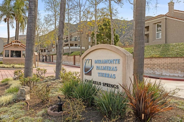 community sign with a mountain view