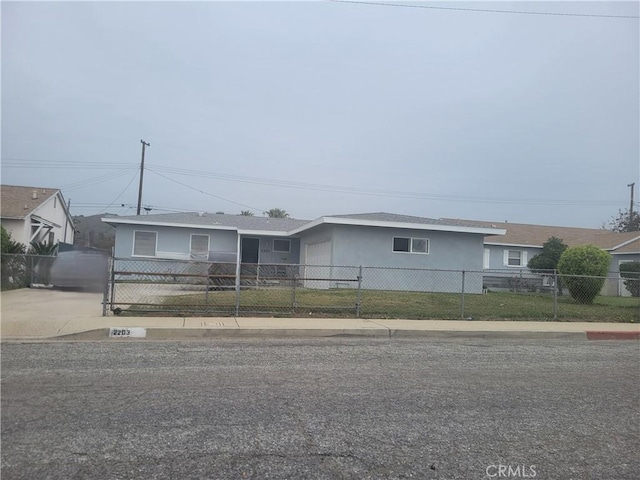 view of front of house featuring a garage, a fenced front yard, concrete driveway, and stucco siding