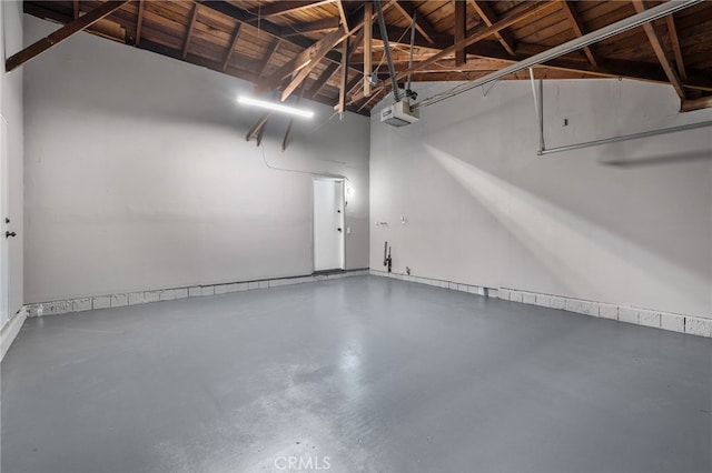 garage featuring wooden ceiling and a garage door opener