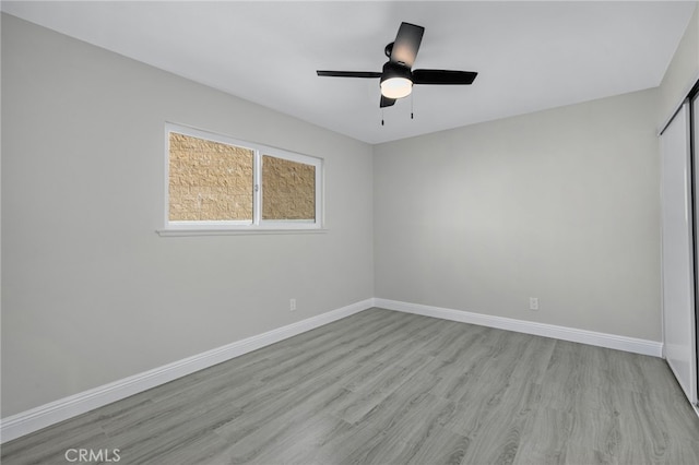 unfurnished room featuring ceiling fan, baseboards, and wood finished floors