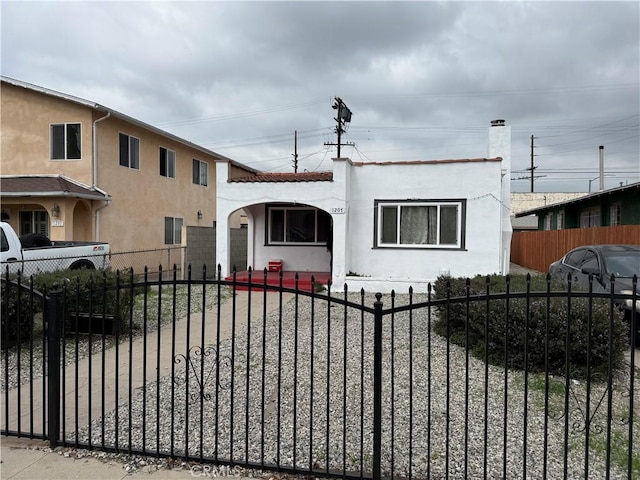 view of front of home featuring a fenced front yard and stucco siding