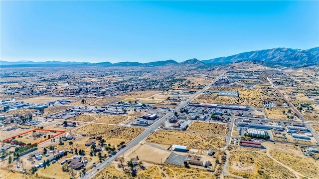 aerial view featuring a mountain view and view of desert